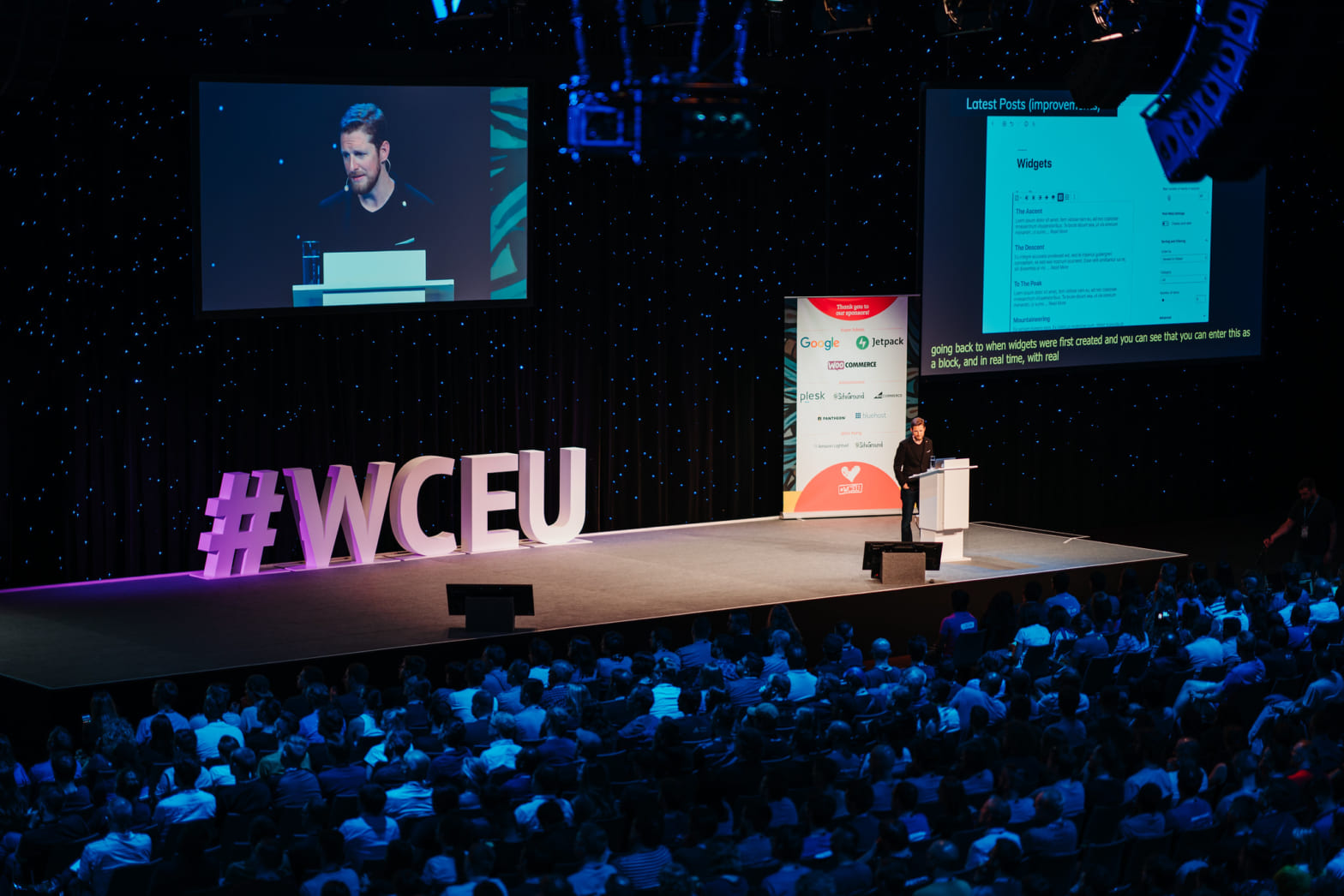 Photo from balcony onto Stage w/ Matt Mullenweg and big #WCEU sign